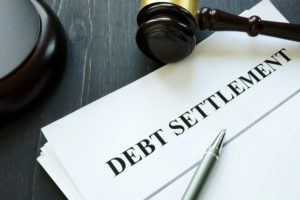 Debt Settlement agreement papers with gavel. - GEM DEBT LAW